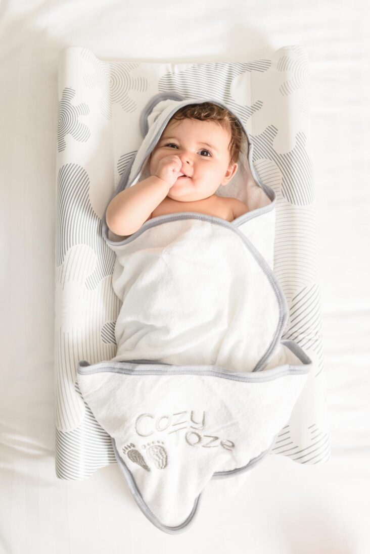 Baby using changing mat with cozytoze